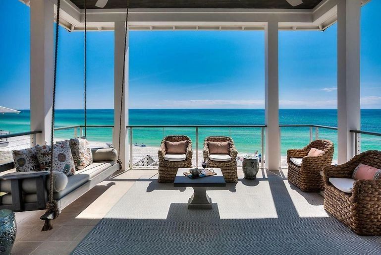 Beachfront interior with floor-to-ceiling windows and ocean view