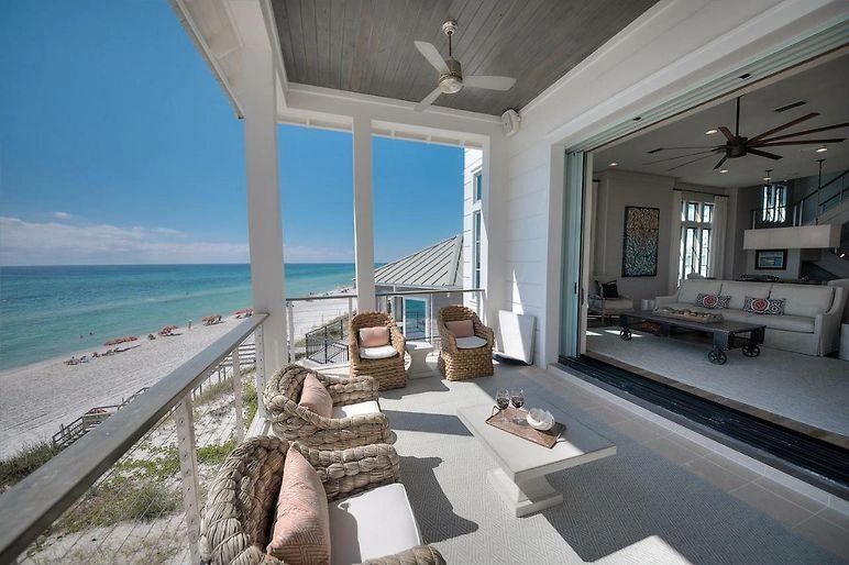 Beachfront porch with wicker seating and ocean view
