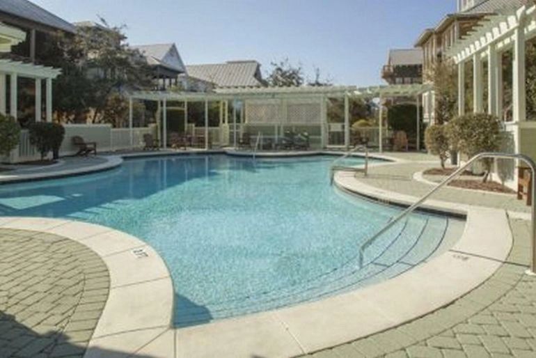 Resort pool with turquoise water and residential buildings