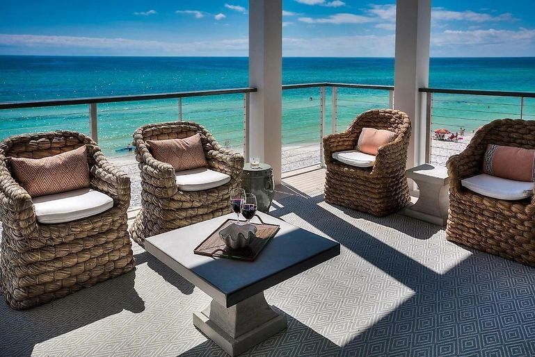 Beachfront lounge with rattan armchairs and ocean view