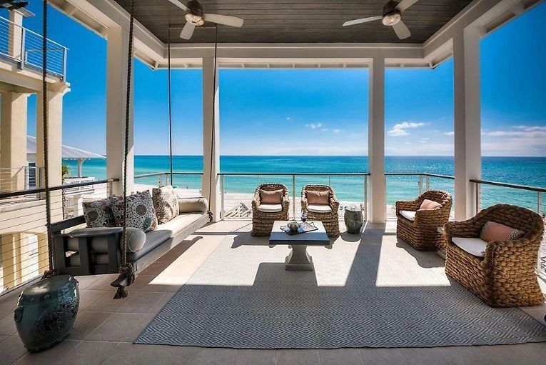 Modern beachfront living room with floor-to-ceiling windows