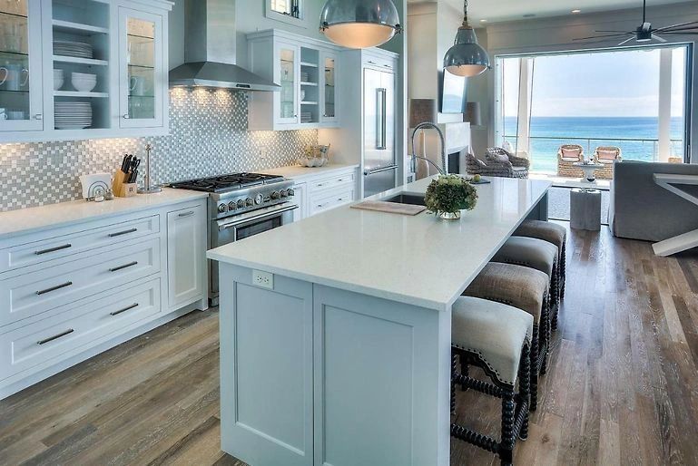Luxury kitchen with light blue cabinetry and ocean view