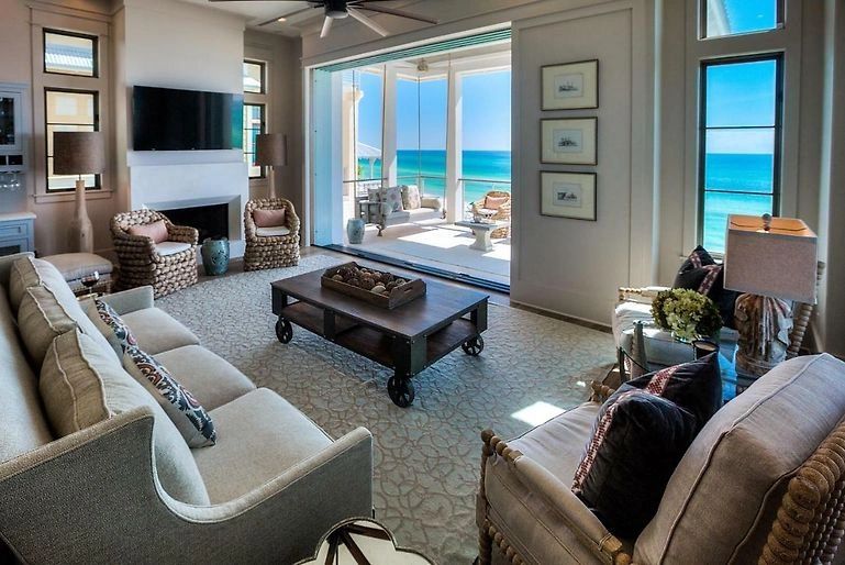 Beachfront living room with curved sectional and fireplace