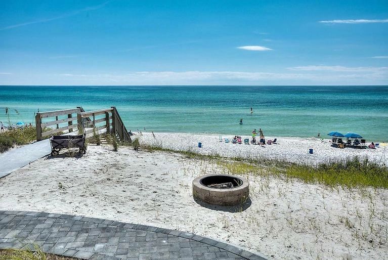 Beach landscape with turquoise water and dune gate