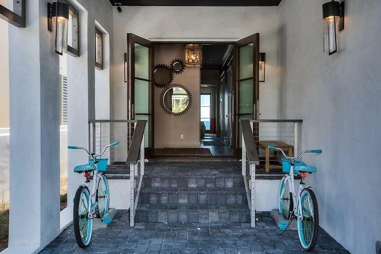 Covered porch with turquoise bicycles and double doors